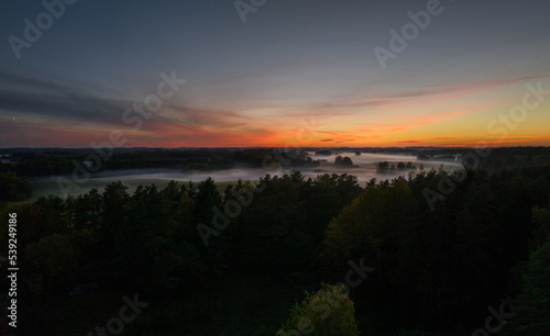 An autumn evening in the fields of Latgale is decorated with fog and sunset.