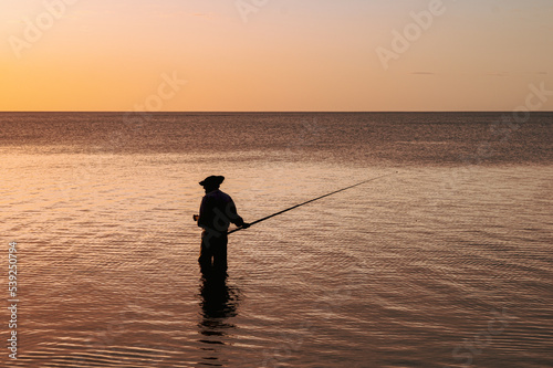Man fishing at sunset, Tombeau Bay, Mauritius