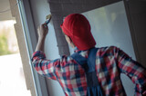 Experienced painter engaged in indoor wall painting