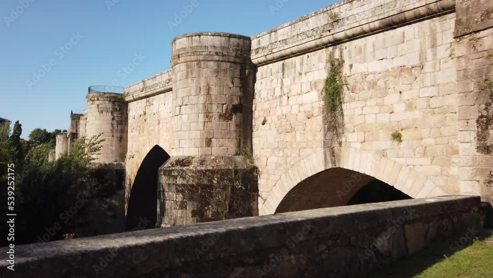 DOLLY SHOT - The Old Bridge over Minho River is a medieval footbridge built on Roman foundations in Ourense, Spain. DOLLY SHOT - The Old Bridge over Minho River is a medieval footbridge built on Roman foundations in Ourense, Spain.