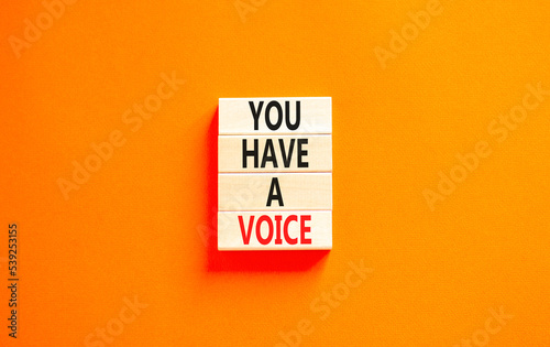 You have a voice symbol. Concept words You have a voice on wooden blocks. Beautiful orange table orange background. Business, psychological you have a voice concept. Copy space.
