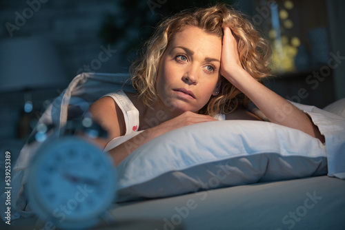 troubled sleepless woman in bed photo