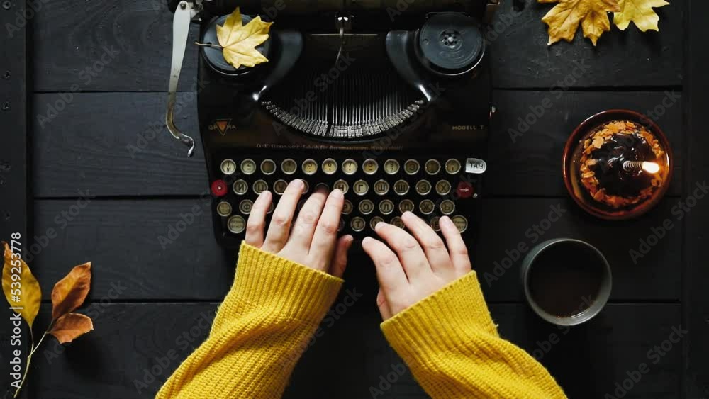 Hand of young woman writer on old typewriter