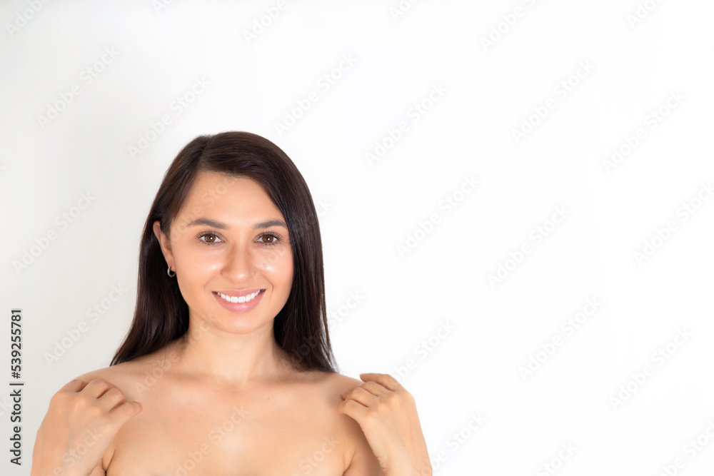 Beautiful young woman brunette with natural beauty and natural makeup on a white background. Space for text. Beautiful young woman brunette with natural beauty and natural makeup on a white background. Space for text.