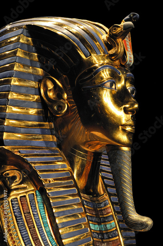 detail of the golden mask of tutankhamun on black background