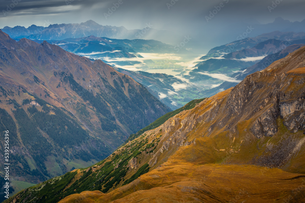 Misty valley from above Grossglockner and mountain landscape at dawn, Austria