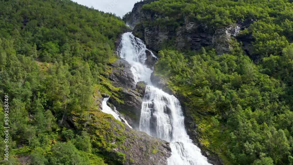 waterfall formed from the melting of glaciers in the mountains, the water of a beautiful turquoise color scatter over the stone slope waterfall formed from the melting of glaciers in the mountains, the water of a beautiful turquoise color scatter over the stone slope