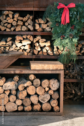 Shelves with neatly stacked chopped firewood. Preparing firewood for the winter. Energy crisis.