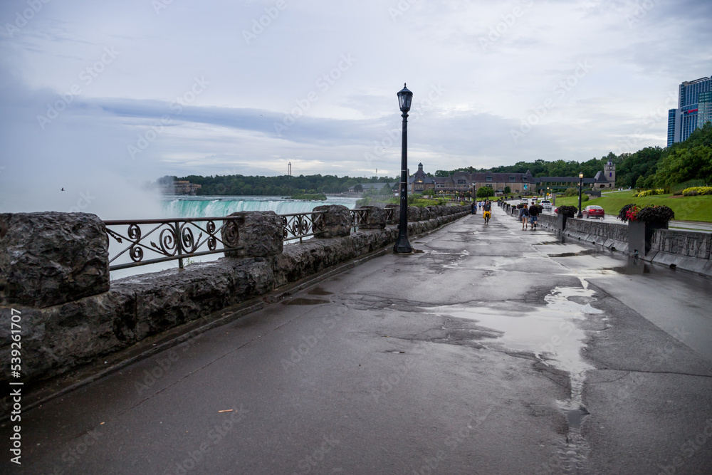 Niagara falls promenade after rain. few people, clean territory, wet pavement