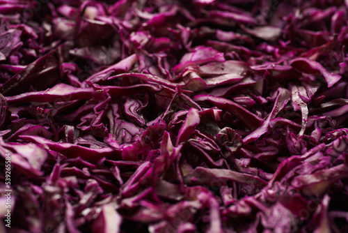 German red cabbage chopped in fine stripes filling the frame, a background