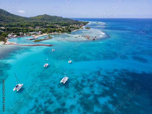 Aerial drone of luxury yachts anchored in tropical exotic island with crystal clear turquoise sea and  © luciano