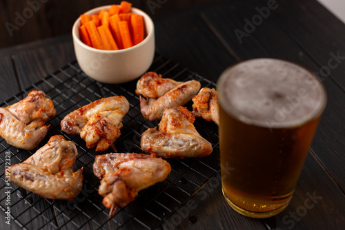 Chicken wings in BBQ sauce, beer appetizer, dinner