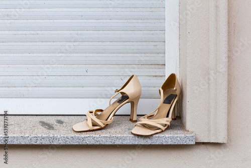 Used, old, beige women's shoes placed on a window sill for take away, Berlin-Friedrichshain, Germany
