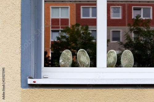 Two pairs of shoes in a window, Berlin-Friedrichshain, Germany