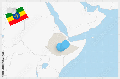 Map of Ethiopia with a pinned blue pin. Pinned flag of Ethiopia.