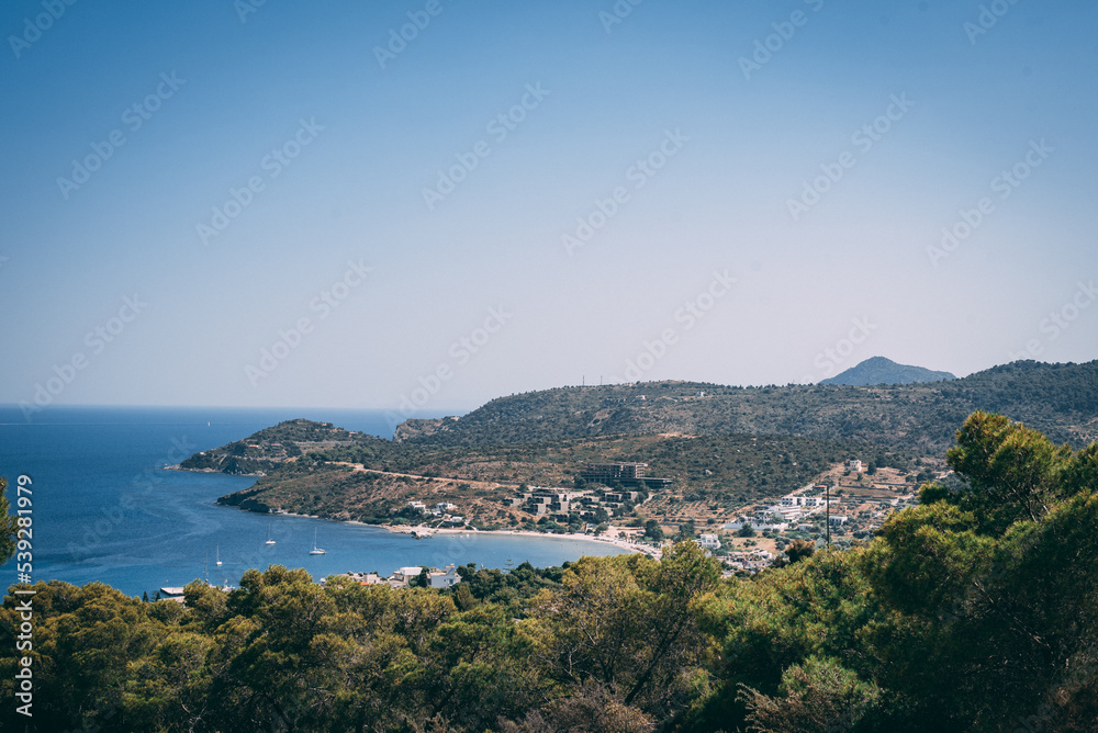 Coastal hills frame a serene Mediterranean bay, where the sea stretches out invitingly.