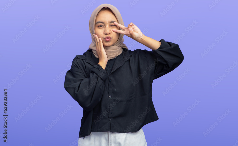Asian Muslim Woman with excited expression Isolated on purple background Asian Muslim Woman with excited expression Isolated on purple background
