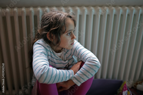 Young girl 6-7 years old looks to the side