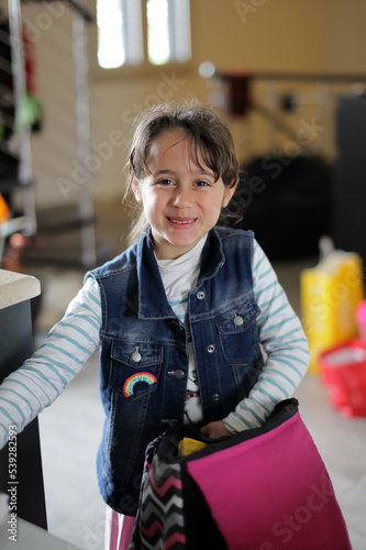 Young girl 6-7 years old looks straight ahead