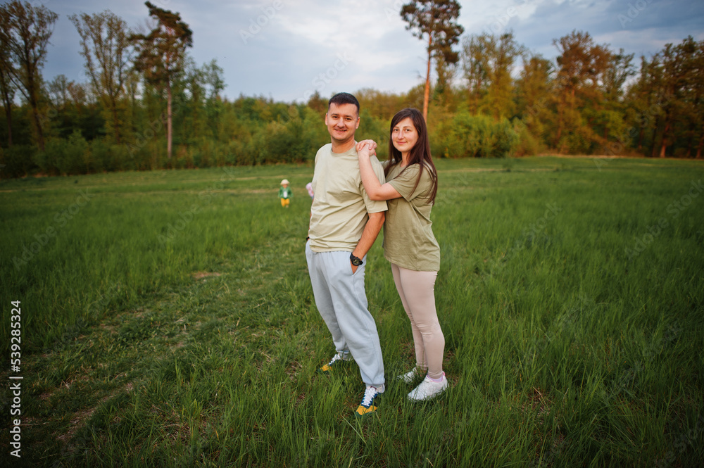 Couple with kids together at meadow. Couple with kids together at meadow.