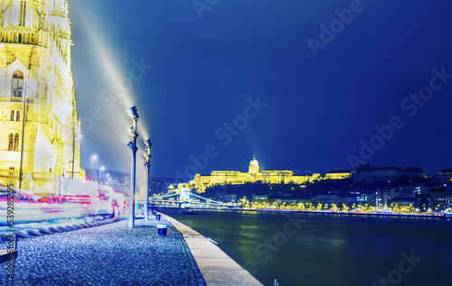Amazing view on  Royal Palace (Budavari Shiklo or Budai Var)   at amazing blue hour with blue slyness of the beginning  evening and yellow lights of illumination and Széchenyi Bridge