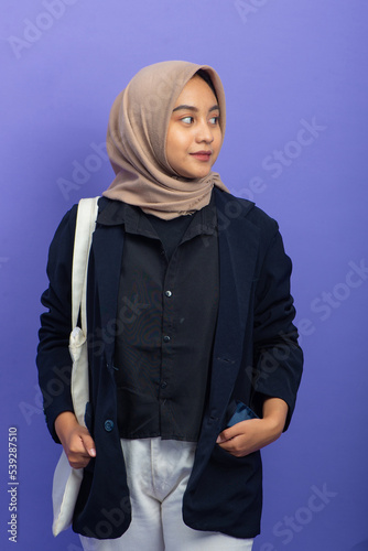 Portrait Asian Muslim Woman with Confident Gesture on Purple Background