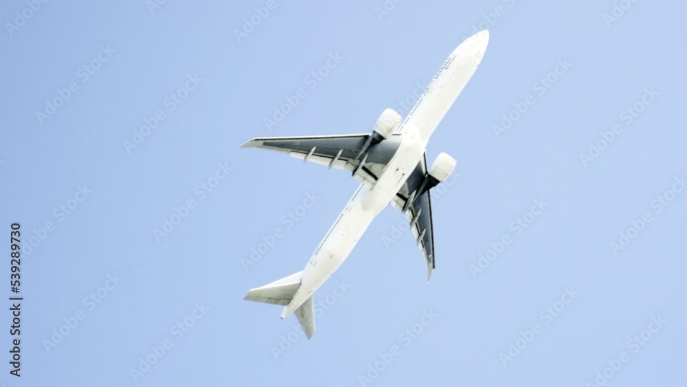 the plane is flying against a background of blue sky and sun the plane is flying against a background of blue sky and sun