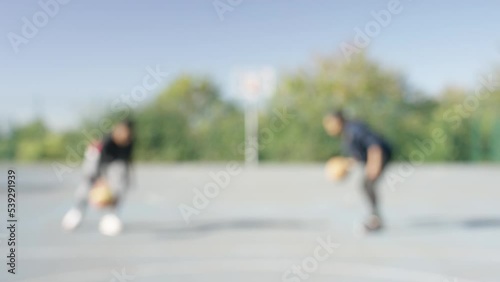 Wallpaper Mural Blurred background of two blurred people dribbling basketballs on a basketball playground Torontodigital.ca