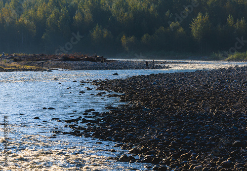 People along river fishing in October