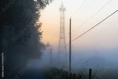Obraz na płótnie Power tower in early morning fog w salonie