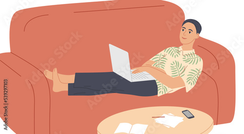 Man lying on the sofa with laptop.