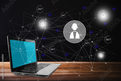 Tech support 24.7 icons on virtual screen and laptop