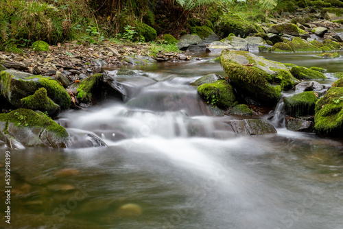 Long exposure of a waterfall on the Horner Water river in Horner woods in Somerset © tom