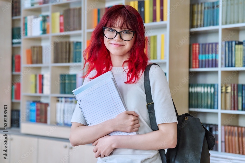 Portrait of teenage female student looking at camera in library Portrait of teenage female student looking at camera in library