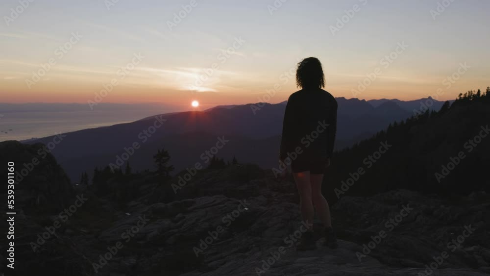 Adventurous Woman Hiker on top of Canadian Mountain Landscape. Sunny Sunset Sky. Top of Mt Seymour near Vancouver, British Columbia, Canada. Adventure Travel Concept Adventurous Woman Hiker on top of Canadian Mountain Landscape. Sunny Sunset Sky. Top of Mt Seymour near Vancouver, British Columbia, Canada. Adventure Travel Concept