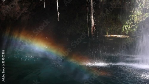 rainbow in the jets of water when the waterfall falls into the lake. High quality FullHD footage