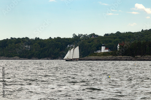 Sailboat with lighthouse in the background