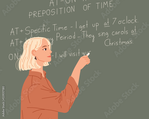 English teacher writes on a chalkboard. Foreign language lesson