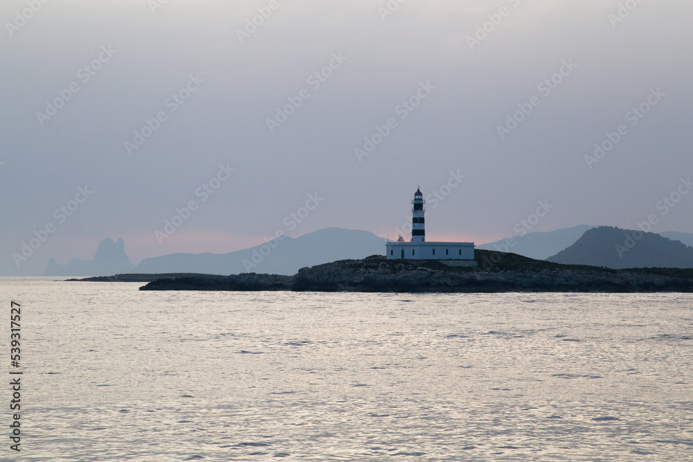 Lighthouse on a Mediterranean island during sunset. Lighthouse on a Mediterranean island during sunset.