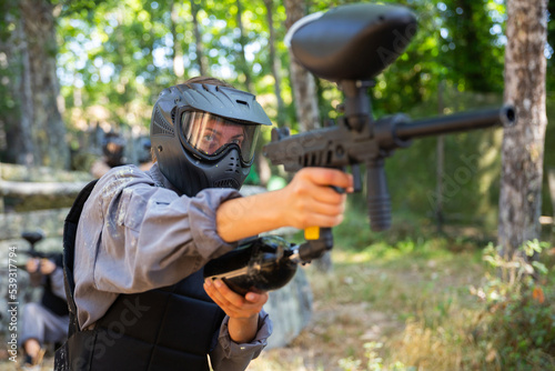 Paintball player recklessly aims with a gun on the battlefield