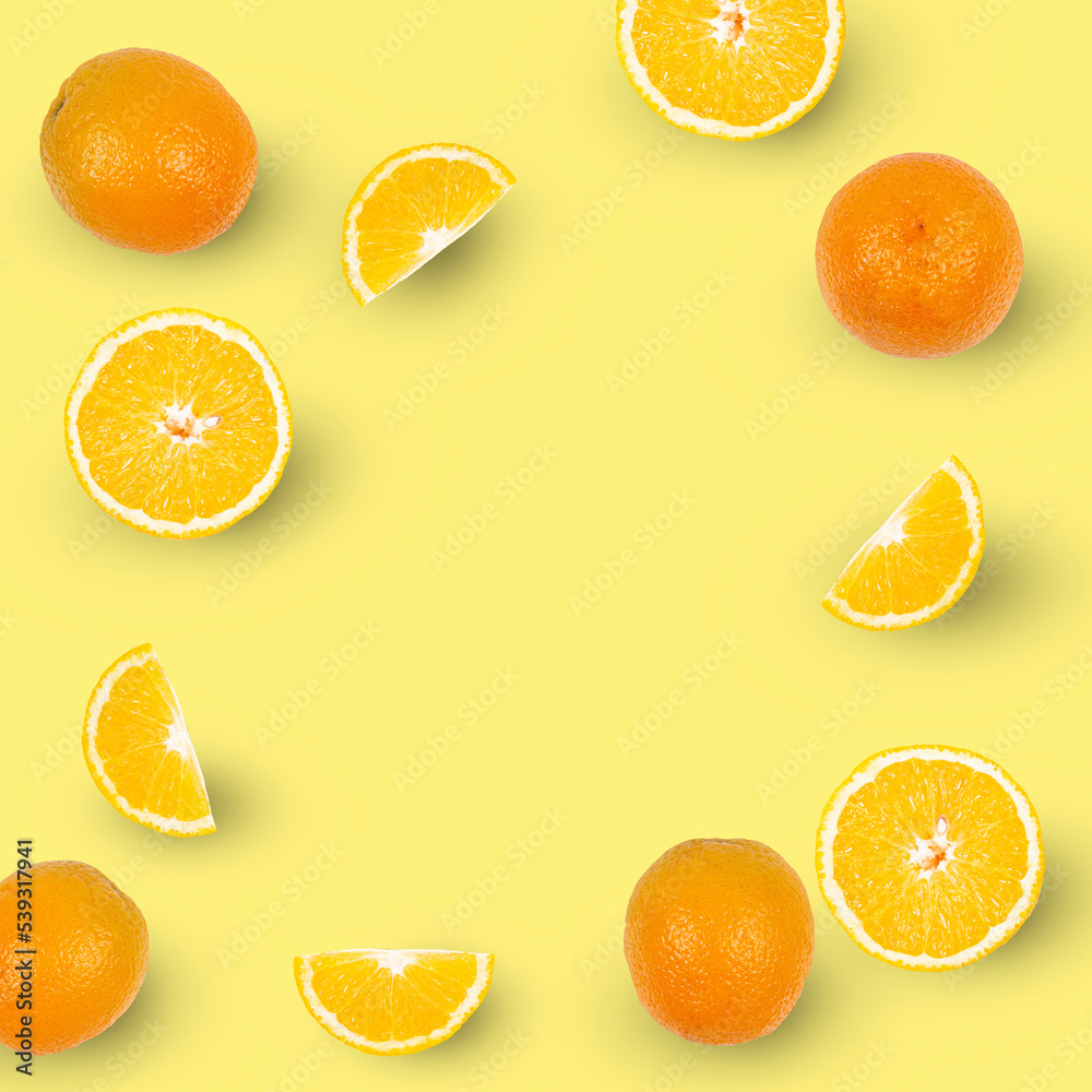 Oranges and slices of oranges isolated on yellow background, copy space