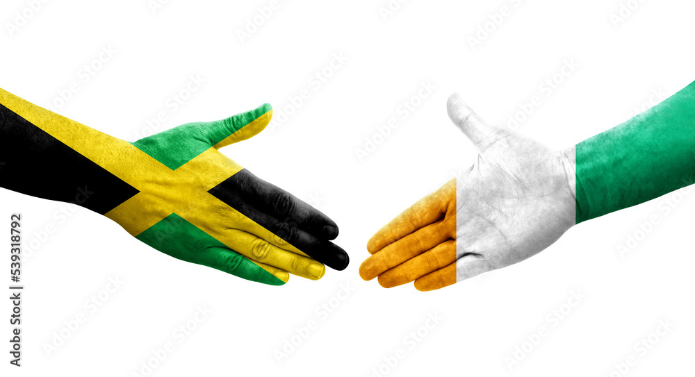 Handshake between Ivory Coast and Jamaica flags painted on hands, isolated transparent image. Handshake between Ivory Coast and Jamaica flags painted on hands, isolated transparent image.