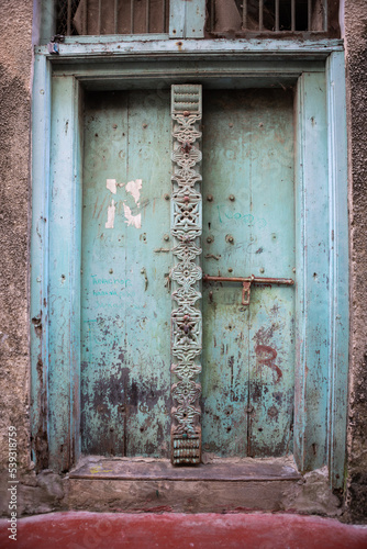 Antique old wooden door. Beautiful colour. Bright sunny day.  photo