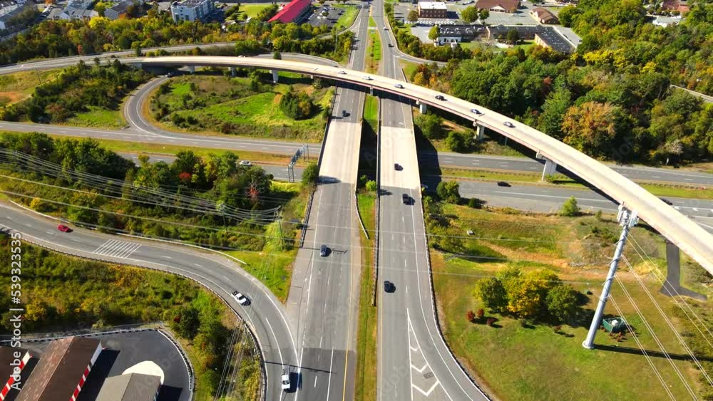 Multi-lane highway with heavy trucks and cars at high speed. View from a drone on a sunny day. Multi-lane highway with heavy trucks and cars at high speed. View from a drone on a sunny day.