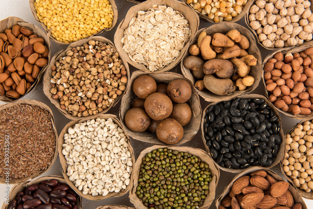 Many cereals such as walnuts, macadamia, green peas, almonds and others isolated on white background. Many cereals such as walnuts, macadamia, green peas, almonds and others isolated on white background.