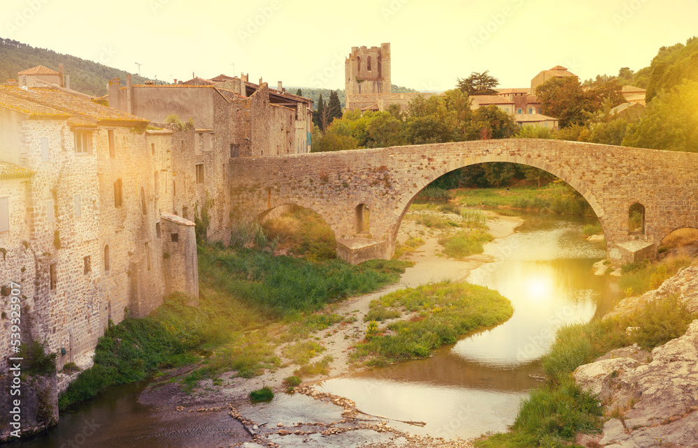 Medieval vaulted arch bridge over Orbieu river in Lagrasse, France..