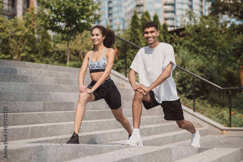 A girl and a guy having a workout outside