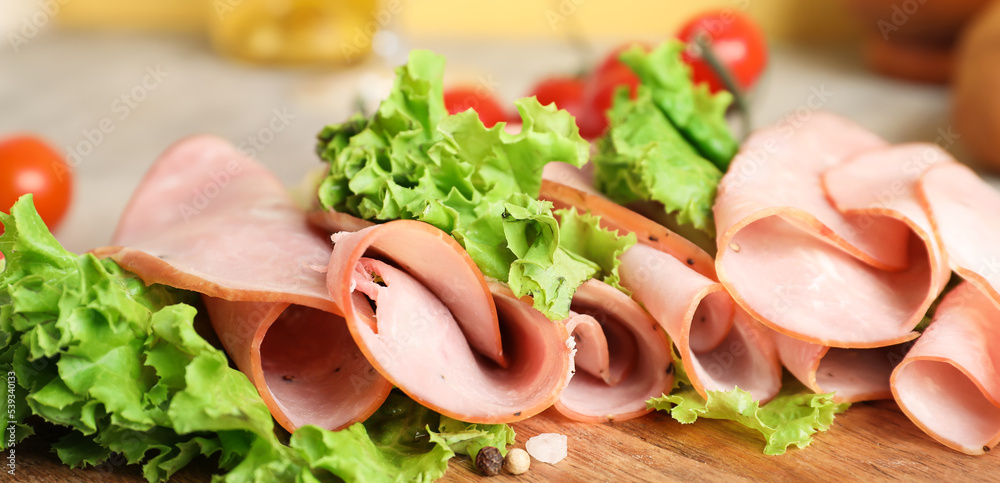 Slices of tasty ham and lettuce, closeup