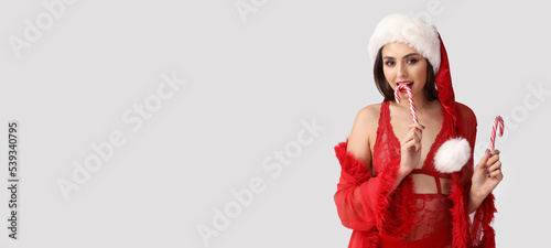 Sexy young woman in Santa h...