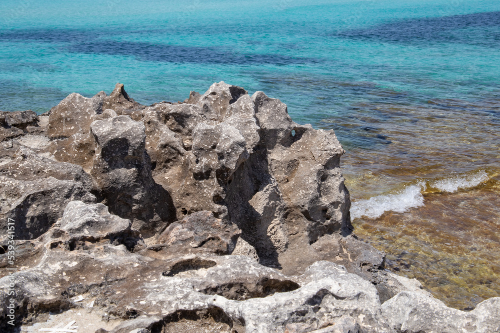 Rocky beach with a turquoise blue sea and waves in spain Rocky beach with a turquoise blue sea and waves in spain